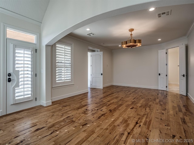 interior space with hardwood / wood-style flooring and crown molding