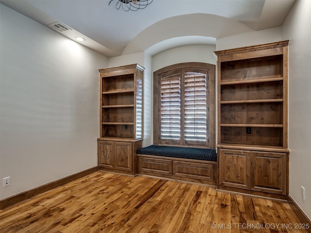 interior space featuring vaulted ceiling and hardwood / wood-style floors