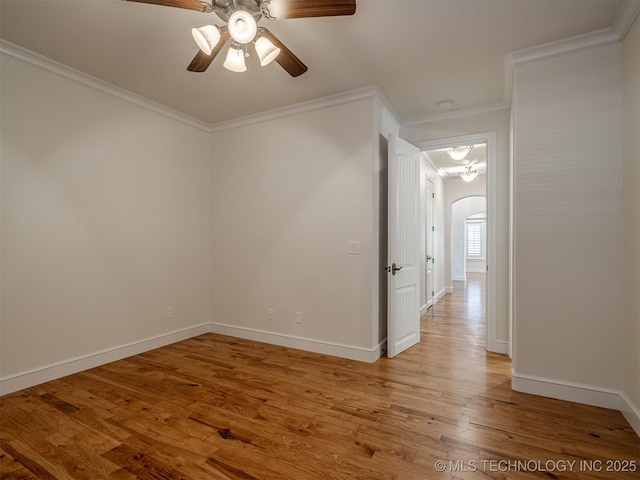 unfurnished room with ornamental molding, ceiling fan, and light wood-type flooring