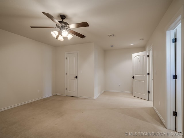 empty room featuring light carpet and ceiling fan