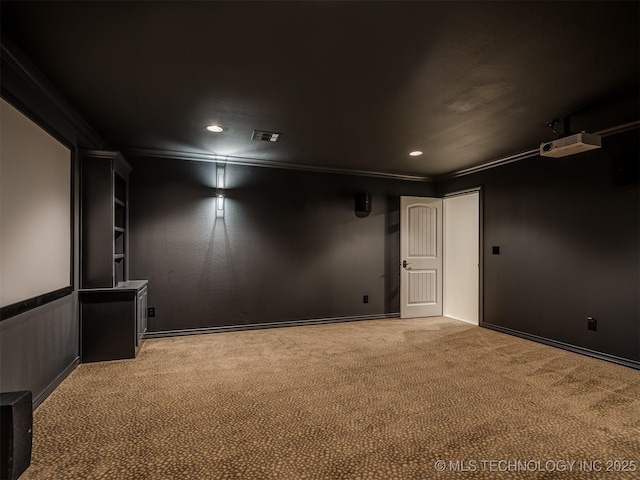 cinema room with crown molding and carpet