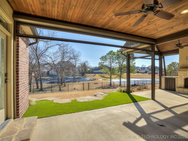 view of patio / terrace featuring ceiling fan and an outdoor stone fireplace