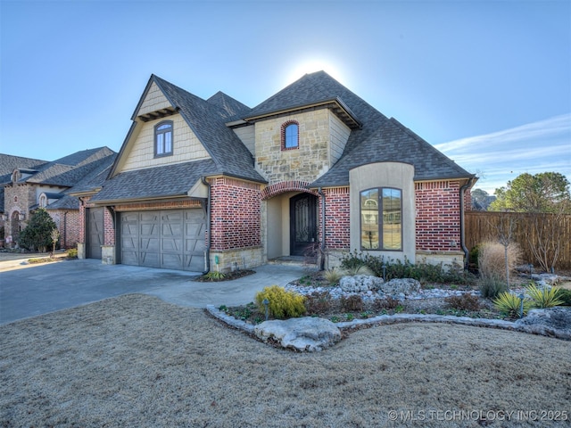 french country style house with a garage