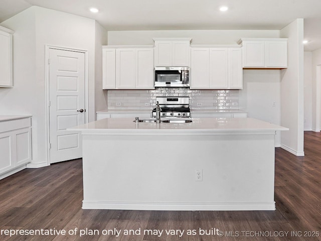 kitchen with stainless steel appliances, an island with sink, and white cabinets