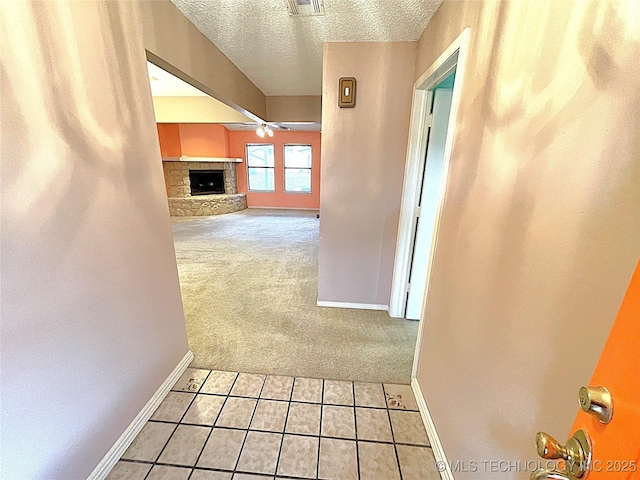 corridor featuring carpet and a textured ceiling