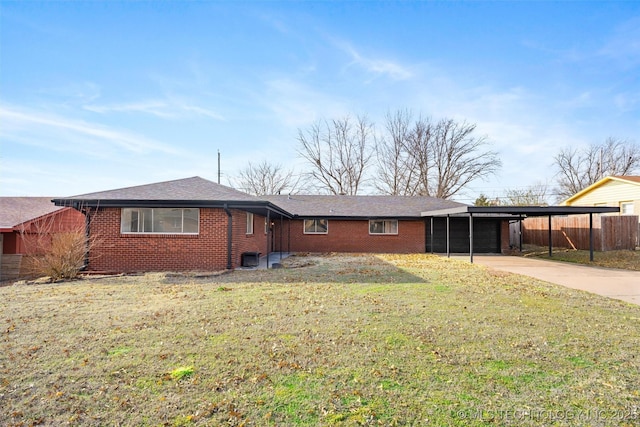 exterior space with a front lawn and a carport