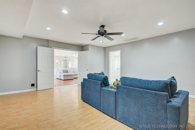 living room featuring wood-type flooring and ceiling fan