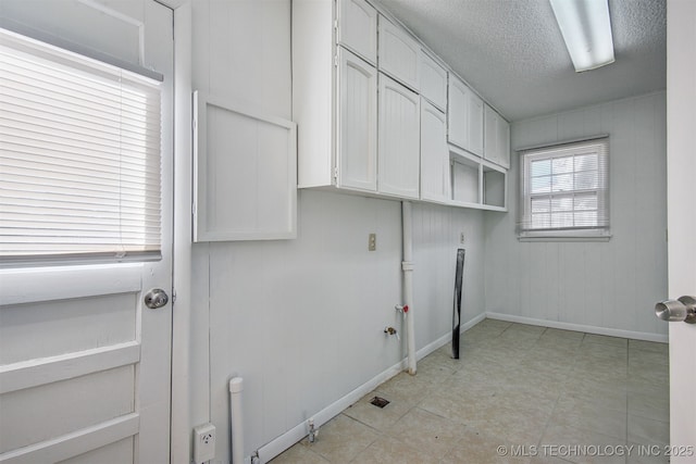 washroom with cabinets and a textured ceiling