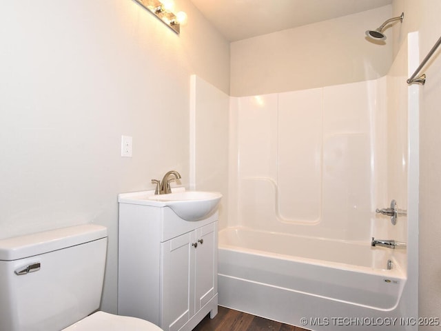 full bathroom featuring vanity, hardwood / wood-style floors, shower / washtub combination, and toilet