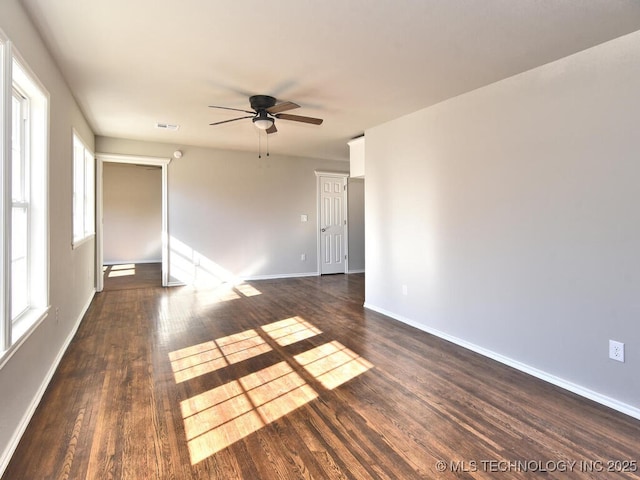 unfurnished room with dark wood-type flooring and ceiling fan