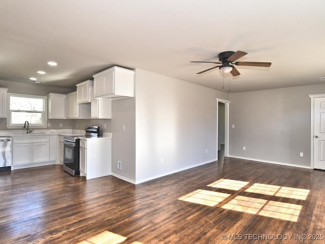 kitchen with white cabinetry, sink, dark wood-type flooring, and appliances with stainless steel finishes