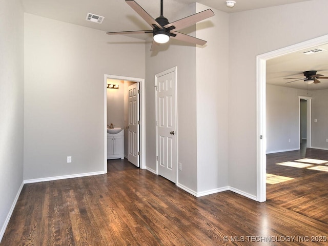 unfurnished bedroom with ceiling fan, dark hardwood / wood-style flooring, sink, and ensuite bath