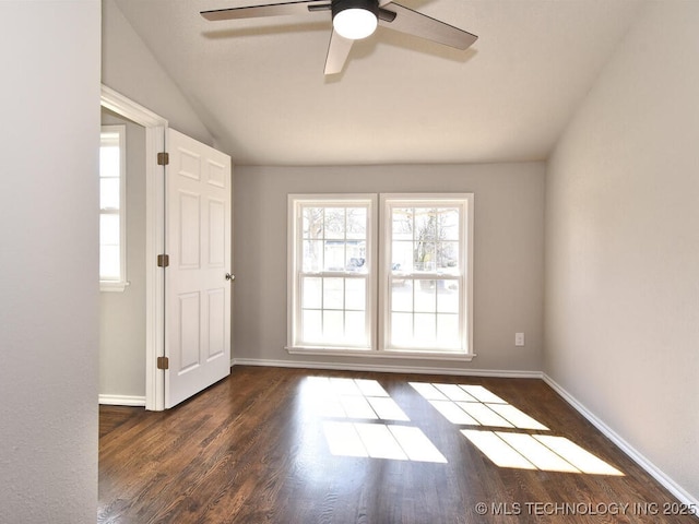 empty room with dark wood-type flooring, ceiling fan, and lofted ceiling