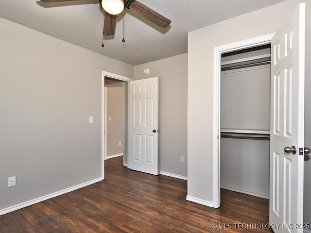 unfurnished bedroom featuring dark hardwood / wood-style flooring, a closet, and ceiling fan