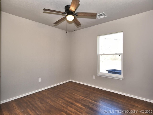 unfurnished room with dark wood-type flooring and ceiling fan