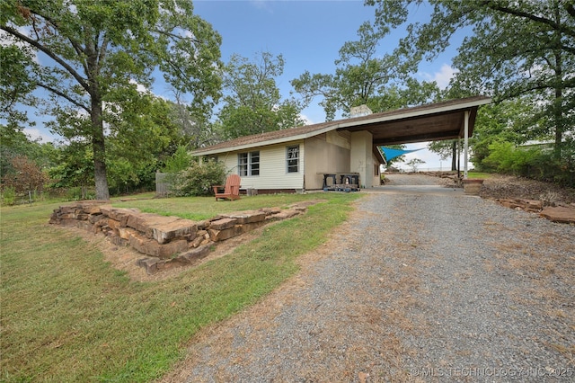 single story home with a front yard and a carport