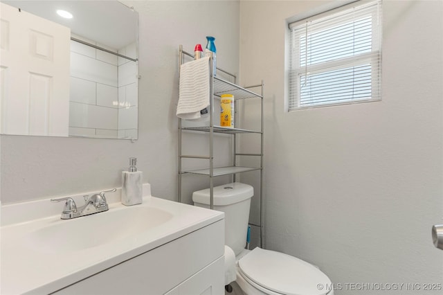 bathroom featuring toilet and vanity