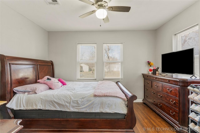 bedroom featuring visible vents, wood finished floors, and a ceiling fan