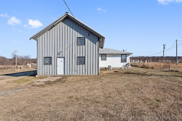 back of house with a lawn