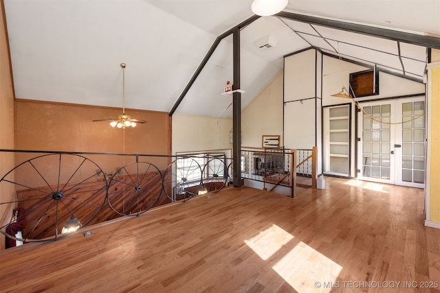 additional living space featuring ceiling fan, wood-type flooring, french doors, and vaulted ceiling