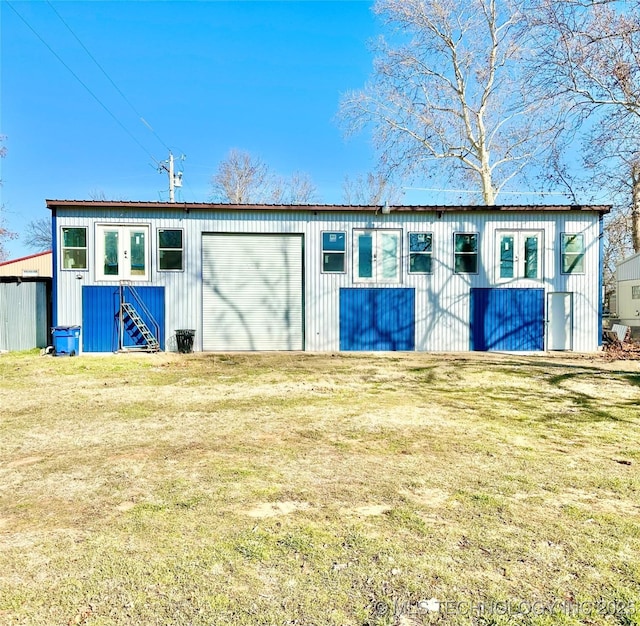 view of outbuilding featuring a garage and a lawn