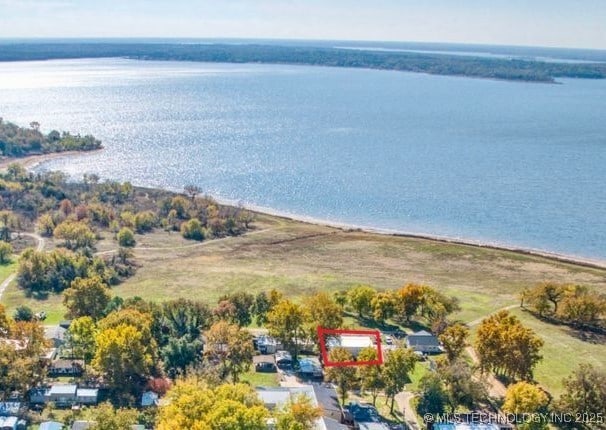 aerial view with a water view and a beach view