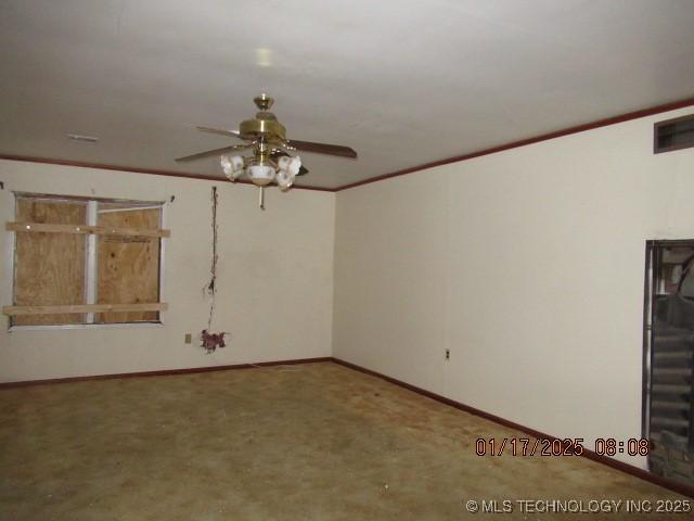 empty room featuring ceiling fan and carpet