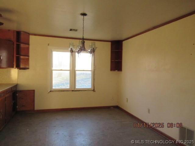 unfurnished dining area featuring an inviting chandelier