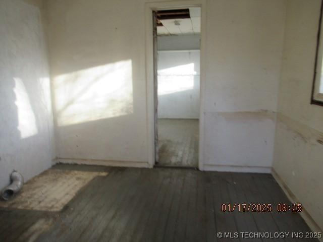 empty room featuring dark wood-type flooring