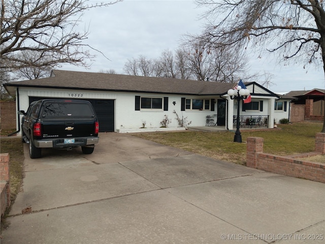 ranch-style home featuring a garage and a front lawn