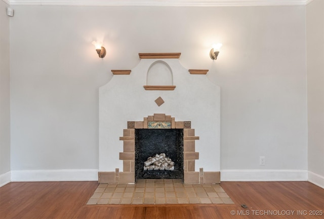 1531 S Florence Ave, Tulsa, OK 74104 - unfurnished living room with crown molding, a fireplace, and wood-type flooring