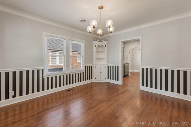1531 S Florence Ave, Tulsa, OK 74104 - unfurnished room with dark wood-type flooring, ornamental molding, and an inviting chandelier