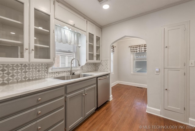 1531 S Florence Ave, Tulsa, OK 74104 - kitchen with decorative backsplash, sink, hardwood / wood-style flooring, stainless steel dishwasher, and gray cabinetry