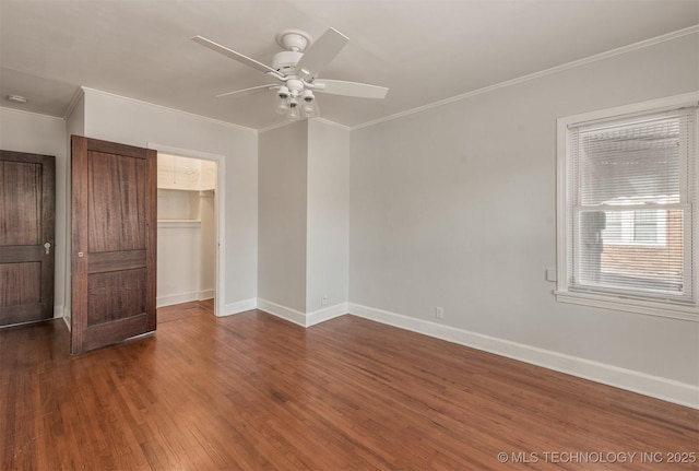 1531 S Florence Ave, Tulsa, OK 74104 - unfurnished bedroom with crown molding, ceiling fan, dark hardwood / wood-style floors, a spacious closet, and a closet