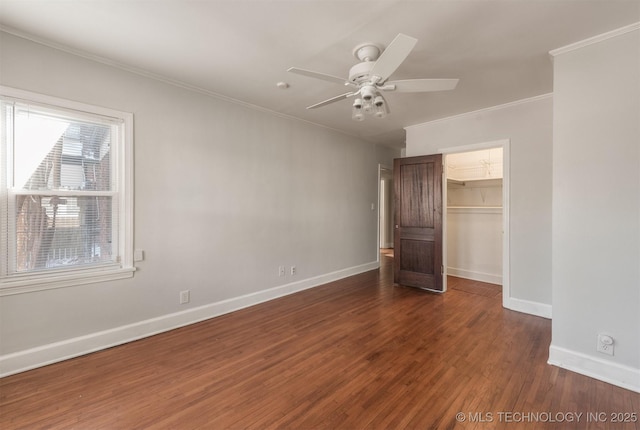 1531 S Florence Ave, Tulsa, OK 74104 - unfurnished bedroom with ceiling fan, dark wood-type flooring, a walk in closet, ornamental molding, and a closet