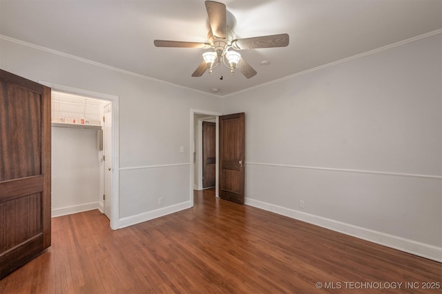 1531 S Florence Ave, Tulsa, OK 74104 - unfurnished bedroom featuring hardwood / wood-style floors, a walk in closet, a closet, ceiling fan, and crown molding