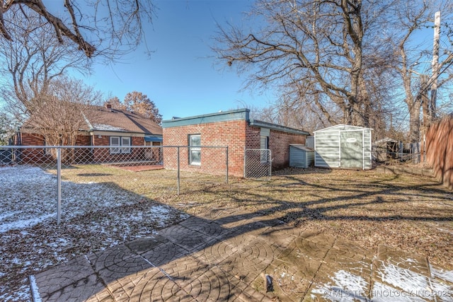 1531 S Florence Ave, Tulsa, OK 74104 - snow covered rear of property with a shed and a yard