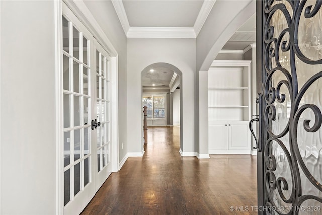 foyer featuring ornamental molding and dark hardwood / wood-style floors