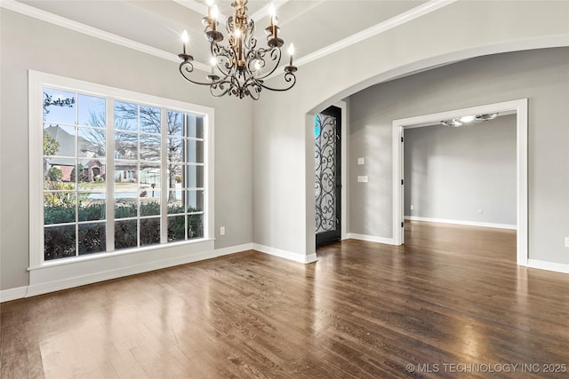 empty room featuring dark wood-type flooring and ornamental molding