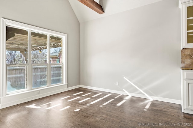 spare room with beamed ceiling, a healthy amount of sunlight, dark wood-type flooring, and high vaulted ceiling