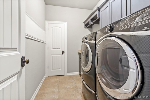 clothes washing area with light tile patterned floors and washer and clothes dryer