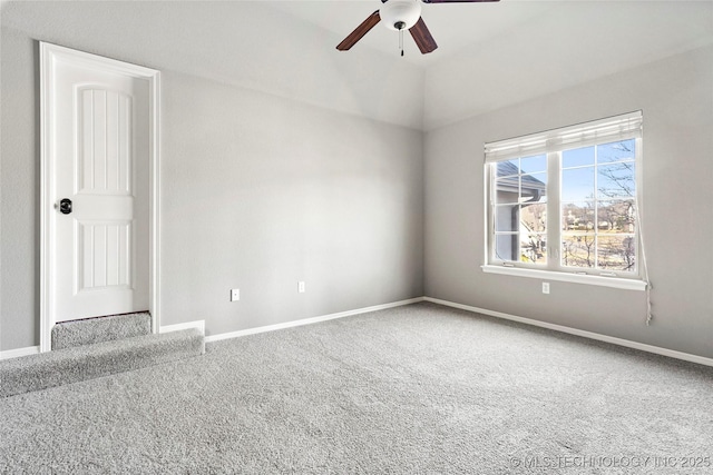 carpeted empty room with ceiling fan and vaulted ceiling