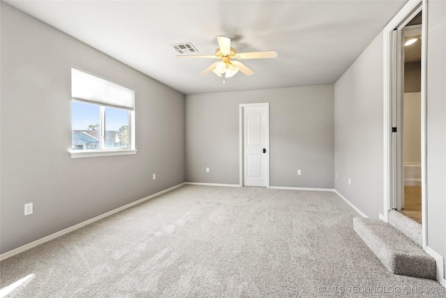 spare room with carpet floors and ceiling fan