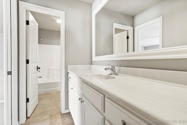 bathroom featuring tile patterned floors, washtub / shower combination, and vanity