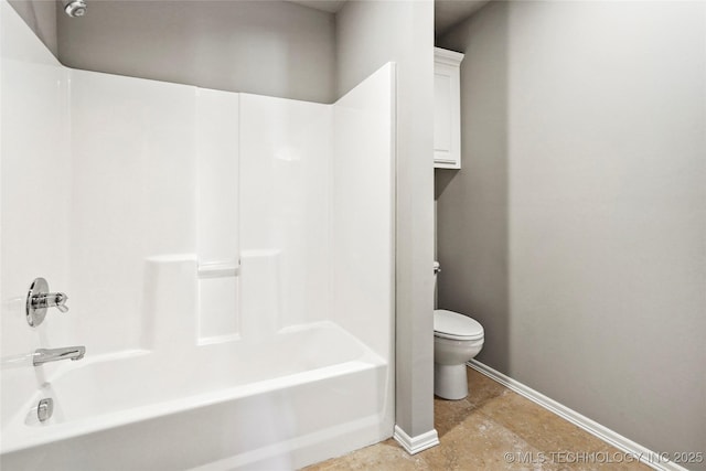 bathroom featuring tub / shower combination and toilet