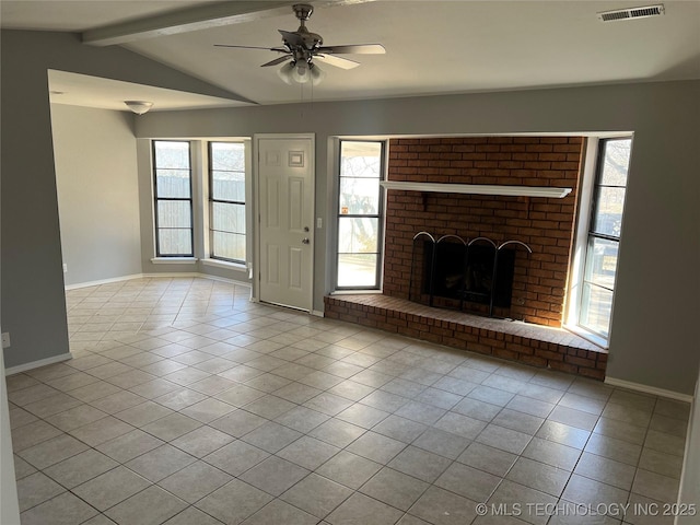 unfurnished living room featuring ceiling fan, a brick fireplace, vaulted ceiling with beams, and light tile patterned floors