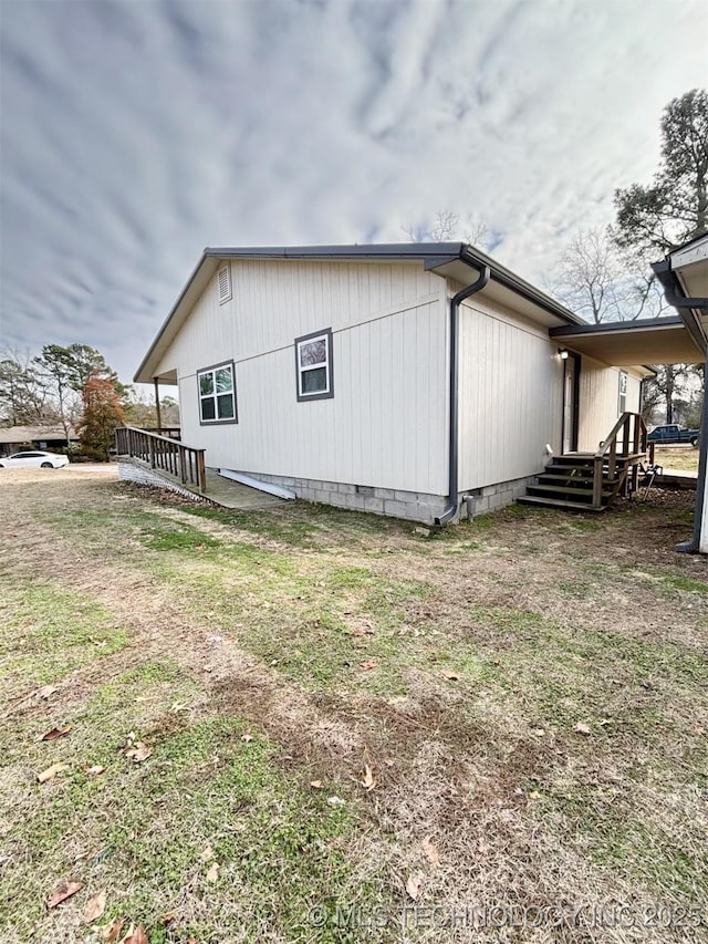 view of property exterior with a lawn