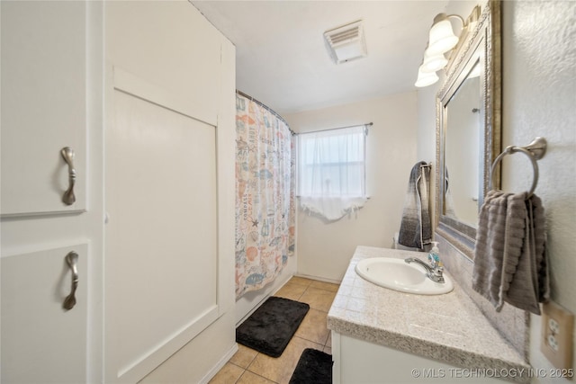 bathroom with vanity, shower / bathtub combination with curtain, and tile patterned flooring