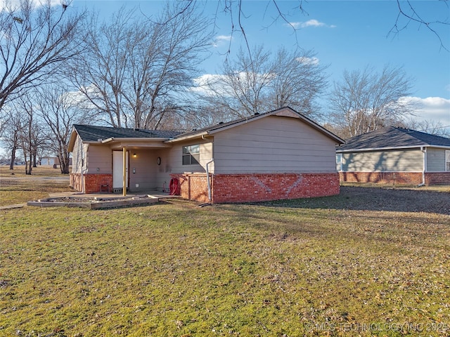 view of front facade with a front yard and a patio