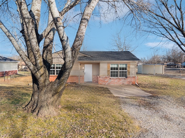 ranch-style house with a front lawn